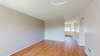 Located at 9091 Holder St in Cypress, CA, this single-story 1-bedroom, 1-bathroom unit offers a practical and comfortable layout across a well-utilized floor plan. Warm hardwood-style flooring runs throughout the main living areas, complemented by neutral gray walls and textured ceilings that lend a clean, cohesive aesthetic.

The open-concept living and dining area is bright and inviting, with a large window dressed in vertical blinds that allows natural light to fill the space. A ceiling fan with a light fixture anchors the dining area, which also features a built-in counter with a sink — a convenient functional detail. The living room flows seamlessly into the rest of the unit, offering a versatile and airy feel.

The kitchen is efficiently designed with white cabinetry, light countertops, a stainless steel sink, a dishwasher, and an electric range. A dedicated pantry closet provides generous additional storage. Recessed lighting keeps the kitchen well-lit.

The bedroom offers a comfortable retreat with plush carpeting, warm neutral tones, and a closet. The full bathroom includes a tub/shower combination, a vanity with storage, and hardwood-style flooring consistent with the rest of the unit.

A connecting hallway ties the layout together, making this a well-organized and functional home.
