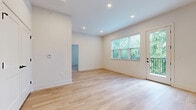 Located at 35 Flax St in Delaware, Ohio, this thoughtfully designed one-bedroom, one-bathroom unit offers a clean, modern aesthetic throughout its well-appointed single floor. The open-concept living and kitchen area serves as the heart of the home, featuring light hardwood flooring, soaring ceilings, and recessed lighting that enhance the bright, airy feel. Large windows invite abundant natural light and offer leafy outdoor views, while a glass-panel door opens directly onto a private balcony. The kitchen is a standout, centered around a generous island with a matte black sink fixture and pendant lighting overhead. White shaker cabinetry, a classic tile backsplash, and a full suite of stainless steel appliances — including a refrigerator, range, microwave, and dishwasher — complete the space. A dedicated pantry provides additional storage. The bedroom is comfortably sized and is complemented by two closets, including a walk-in closet with built-in wire shelving. The full bathroom features a walk-in shower with black-framed glass doors, a white vanity, and wood-look tile flooring that ties the design together. An in-unit laundry area adds everyday convenience, rounding out this well-equipped and stylish home.