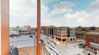 Located at 985 N High St in Columbus, Ohio, this single-floor space sits in the heart of the Short North Arts District, one of the city's most dynamic and walkable urban neighborhoods. The space benefits from a prime position along North High Street, providing direct access to the area's thriving mix of galleries, restaurants, boutiques, and entertainment venues. A standout feature is the elevated outdoor terrace or balcony, framed by bold structural steel columns in a striking orange finish and fitted with metal railing. From this vantage point, sweeping views of the North High Street corridor unfold, showcasing the neighborhood's mix of contemporary mixed-use developments and historic brick buildings beneath open skies. The interior areas, while dimly captured in available imagery, suggest compact, versatile rooms with minimal ambient lighting, including subtle LED accent lighting visible along floor-level trim. The layout spans a single floor, lending itself to a variety of commercial or creative uses. The combination of an urban address, outdoor viewing area, and flexible interior layout makes this space well-suited for businesses seeking high visibility and a strong sense of place within one of Columbus's most active corridors.