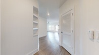 This well-appointed single-story home offers a thoughtfully designed layout with 3 bedrooms, 2 bathrooms, and a generous combined total living area. The interior is finished with a clean, modern aesthetic characterized by crisp white walls, light wood-tone flooring, and black hardware accents throughout.

The open-concept kitchen and living area serves as the heart of the home. The kitchen features white shaker-style cabinetry, white quartz countertops, a stainless steel undermount sink with a matte black faucet, stainless steel appliances, and stylish pendant lighting — all complemented by abundant natural light from multiple windows.

The hallway leads to three well-sized bedrooms, each equipped with ceiling fans, wood-look flooring, and windows that bring in natural light and outdoor views. The spacious primary bedroom includes its own dedicated closet space. Across the home, five closets provide exceptional storage, including walk-in closets outfitted with wire shelving systems for organized functionality.

The two bathrooms continue the modern design language with white vanities, ample drawer storage, black hardware fixtures, and wood-look flooring. Built-in shelving in the hallway adds additional display and storage options. The overall ambiance is bright, clean, and move-in ready.