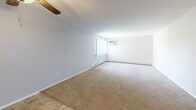 Located at 195 W Kennett Rd in Pontiac, MI, this single-floor residence offers three bedrooms, one bathroom, and a well-organized layout designed for comfortable everyday living. The kitchen features warm honey-toned wood cabinetry, ample upper and lower storage, light countertops, a stainless steel sink, and tile flooring — equipped with a stainless refrigerator and range. A central hallway connects the main living areas, providing a practical flow throughout the home. The generously sized primary bedroom offers an expansive footprint with wide bifold closets featuring gold hardware, neutral carpet, and a window with vertical blinds that invite natural light. The additional bedrooms are similarly appointed with plush carpet, baseboard heating, and windows overlooking the surrounding greenery. A ceiling fan in the main living area adds comfort, while the open layout allows for flexible use of space. The bathroom is clean and functional, featuring a full tiled tub-shower combination with chrome fixtures. Baseboard heating is present throughout, and a wall-mounted A/C unit provides cooling in the primary bedroom. The space maintains a neutral, move-in-ready aesthetic throughout.
