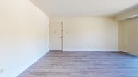 Located at 101 Village of Pine Ct in Windsor Mill, Maryland, this single-floor, 3-bedroom, 2-bathroom home offers a clean and functional layout designed for comfortable everyday living. Consistent hardwood-style flooring runs throughout the home, lending a cohesive and modern feel to every room.

The living room provides an open, airy feel with neutral walls and ample space for a variety of furniture arrangements. The kitchen features warm, rich wood cabinetry, light granite-style countertops, and a pendant light above a dining area framed by a natural-light-admitting window with blinds — a welcoming spot for meals. White appliances, including a full-size refrigerator, complete the space.

The primary bedroom is generously sized, with a window that draws in natural light and an adjacent closet for storage. The two additional bedrooms are well-proportioned with the same consistent flooring and neutral wall tones, offering versatility as guest rooms, offices, or personal spaces. Both bathrooms are clean and practical, with one featuring a full tub-shower combo with white tile surround.

A connecting hallway ties all the rooms together efficiently. Throughout the home, bright white trim, neutral paint tones, and natural light create a calm, move-in-ready atmosphere.