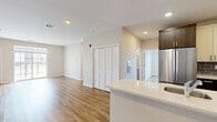 Located at 78 Murray Street in Elizabeth, NJ, this well-appointed 2-bedroom, 2-bathroom residence offers a thoughtfully designed single-floor layout with a clean, modern aesthetic throughout. Warm hardwood-style flooring flows seamlessly across the open-concept living and kitchen areas, creating a bright and cohesive atmosphere enhanced by recessed lighting.

The kitchen is a standout feature, equipped with stainless steel appliances including a French door refrigerator, gas range, and microwave. Two-tone cabinetry — pairing dark wood lower cabinets with crisp white uppers — is complemented by quartz countertops and a grey subway tile backsplash, giving the space a contemporary yet functional character.

The spacious primary bedroom includes an en-suite bathroom and generous closet space with wire shelving systems. The second bedroom benefits from natural light through a large window with neighborhood views. Both bathrooms are finished with tile flooring and surround, sliding glass tub-shower enclosures, and warm wood-toned vanities with well-lit mirrors.

Storage is plentiful throughout, with five closets distributed across the unit. An outdoor terrace accessible from the residence provides open-air space with views of the surrounding Elizabeth cityscape, adding an appealing extension to the living area.