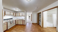Located at 28815 Jamison St in Livonia, Michigan, this one-bedroom, one-bathroom unit offers a functional and efficient single-floor layout. The space is thoughtfully organized to maximize utility across its compact footprint.

The kitchen features cream-toned cabinetry with warm wood trim accents, a coil-burner electric range, and light countertops that provide ample prep space. Upper and lower cabinets offer generous storage, making the kitchen practical for everyday use.

The bedroom is a comfortable, well-proportioned room finished with neutral wall-to-wall carpeting and warm wood baseboard trim. A set of sliding double doors opens to a built-in closet, providing convenient wardrobe storage. A baseboard heater ensures year-round comfort.

The bathroom is notably spacious and features wood-look luxury vinyl plank flooring, a tub-shower combo with a curtain, and a wall-mounted grab bar, indicating accessibility-conscious design. A baseboard heater, vanity with storage, and clean white walls complete the functional space.

Throughout the unit, neutral tones, warm wood accents on doors and trim, and baseboard heating systems create a consistent and practical aesthetic. The layout, as shown in the floor plan, connects all rooms efficiently, making this a well-suited space for comfortable single-occupant living in Livonia, MI.