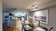 This single-story residence offers a thoughtfully designed open-concept layout that seamlessly connects the main living areas. The kitchen is well-equipped with stainless steel appliances, including an electric range, dishwasher, and refrigerator, complemented by white cabinetry, granite countertops, a tile backsplash, and wood-look flooring. A peninsula with an undermount sink provides additional workspace and a natural transition into the dining area.

The dining space features track lighting overhead and offers a comfortable setting for everyday meals or entertaining. The living room continues the warm aesthetic with wood-look flooring, a ceiling fan, and neutral gray walls that carry throughout the home.

Multiple bedrooms are carpeted for comfort, each featuring large windows with blinds that allow ample natural light. Ceiling fans are present in select bedrooms, enhancing year-round comfort.

The bathrooms are finished with granite countertops, white cabinetry, and wood-look flooring. One bathroom is accessible via a hallway corridor, while another connects directly to a bedroom. The consistent use of neutral tones, updated finishes, and practical layouts gives the entire residence a cohesive, modern character.