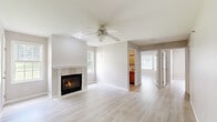 Located at 5218 Plank Rd in Halfmoon, NY, this single-story home offers a well-organized layout across three bedrooms and two bathrooms. Light-toned hardwood flooring runs throughout the home, contributing to a clean, cohesive aesthetic.

The living room serves as the centerpiece of the home, anchored by a tile-surround fireplace framed by two windows that bring in natural light. A ceiling fan adds both function and visual interest to the space. The room connects openly to the rest of the home, creating an easy flow between living and dining areas.

The kitchen features a galley-style layout with cream cabinetry, granite-look countertops, and white appliances, including a range, microwave, and refrigerator. Light hardwood flooring continues here, and a louvered closet door provides additional storage access.

The bedrooms are finished in neutral tones with light hardwood floors, and the primary bedroom offers a comfortable footprint with natural light from a large window overlooking greenery outside.

Both bathrooms are finished with tile flooring and warm wood vanity cabinetry. One bathroom includes a walk-in shower, while the other features a bathtub. Together, they provide practical, functional spaces throughout the home.