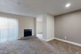 Located at 3636 W Redbird Ln in Dallas, TX, this single-floor, 2-bedroom, 3-bathroom home offers a functional and comfortable layout. The living room serves as the heart of the space, featuring a carpet floor, a striking marble-surround fireplace with a raised hearth, and a sliding glass door fitted with vertical blinds that allows natural light to filter in. A pass-through window connects the living area to the kitchen, enhancing the open feel between spaces. The kitchen is accessible via a dedicated entry, and the layout flows efficiently through a central hallway connecting all rooms. Both bedrooms are carpeted and filled with natural light from windows with blinds. The primary bedroom includes a ceiling fan and is generously proportioned, while the secondary bedroom also features a ceiling fan and closet access. The bathrooms include tub-shower combinations with tile surrounds and wood-look vinyl flooring. With five closets distributed throughout, storage is a notable highlight of this home. The neutral warm-tone walls throughout create a clean, move-in-ready ambiance suitable for a variety of décor styles.