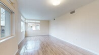 Located at 200 Greenbriar Circle in Petaluma, CA, this well-designed two-bedroom, two-bathroom single-floor residence offers a clean, modern aesthetic throughout. The open living area features light-toned hardwood-style flooring and neutral walls, bathed in natural light through large windows that frame views of the surrounding neighborhood. The space flows seamlessly into a contemporary kitchen outfitted with two-tone cabinetry, white subway tile backsplash, stainless steel appliances including a gas range, built-in microwave, refrigerator, and dishwasher, all complemented by wood-style flooring and ample counter space. Both bedrooms are carpeted for comfort, with the generously sized primary bedroom offering good natural light and access to a dedicated closet. The second bedroom also features carpet flooring and is conveniently situated near the hallway. Each bathroom is finished with wood-toned cabinetry, white countertops, a full tub-shower combination, and wood-style tile flooring. A large mirror in each bath enhances the sense of space. Central HVAC vents are present throughout, and the overall palette of warm neutrals creates a bright, welcoming ambiance ideal for comfortable everyday living.