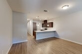 Located at 1610 Jenkins Rd in Bakersfield, California, this two-story home offers four bedrooms and five bathrooms across a thoughtfully designed floor plan. The main level sets a welcoming tone with an open-concept kitchen and living area featuring wood-look hard flooring that flows seamlessly throughout. The kitchen is a standout, showcasing rich dark-brown cabinetry, a classic white subway tile backsplash, stainless steel appliances, and a spacious peninsula with a white countertop and undermount sink — ideal for both meal prep and casual dining. Pendant lighting adds a modern touch overhead. The living area benefits from natural light streaming through windows, creating a bright and airy atmosphere. The entry foyer is open and inviting, with clean white walls and consistent wood-look flooring. Bedrooms are carpeted for comfort, with neutral tones and ample natural light from well-placed windows. Closets provide practical storage with built-in hanging rods. The bathrooms are finished with dark vanity cabinetry, white countertops, wood-look tile flooring, and tub-shower combinations with clean, modern fixtures. A dedicated laundry room and a hallway connecting the upper level round out the functional layout, making this home well-suited for comfortable everyday living.