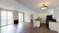 Located in the desirable Westwood neighborhood of Los Angeles, this single-floor residence at 11983 Wellworth Ave offers a well-designed layout with clean finishes throughout. Rich hardwood-style flooring flows seamlessly across the main living areas, creating a warm and cohesive aesthetic.

The open living and dining area is bright and spacious, anchored by a classic fireplace and a sliding glass door that opens to a private balcony, allowing natural light to fill the room. Crown molding adds a refined architectural detail to the ceiling.

The kitchen is thoughtfully designed with white cabinetry, granite-look countertops, a stainless steel sink, and black appliances including a gas range, microwave, and refrigerator. Recessed lighting illuminates the workspace, while a peninsula counter connects the kitchen to the living area, ideal for casual dining or entertaining.

The bedroom offers a generously sized, quiet retreat with neutral tones and a textured ceiling. The bathrooms are finished with white vanities, large mirrors, and shower/tub combinations, maintaining a clean and functional aesthetic consistent with the rest of the home.

Overall, the space presents a comfortable and practical living environment in one of Los Angeles' most sought-after neighborhoods.