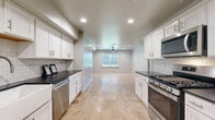 Located at 3915 N Pennsylvania Ave in Oklahoma City, this single-story, one-bedroom, one-bathroom unit offers a thoughtfully designed layout with modern finishes throughout. Polished concrete floors flow seamlessly across the entire space, lending an industrial-modern aesthetic that ties each room together.

The kitchen is a standout feature, showcasing white shaker cabinetry, dark granite countertops, a classic subway tile backsplash, and a full suite of stainless steel appliances including a gas range, built-in microwave, and dishwasher. The kitchen opens directly into the combined dining and living area, which is brightened by natural light from multiple windows and kept comfortable by a ceiling fan overhead.

The spacious primary bedroom offers generous proportions, multiple windows with exterior views, a ceiling fan, and easy access to two closets. The bathroom includes white cabinetry with dark countertops, a wall-mounted shelving unit, and a towel rack. A dedicated laundry room and separate utility room add everyday convenience.

Stylish panel-style interior doors in a muted blue-gray tone add a contemporary touch throughout. Recessed lighting complements the natural light, creating a bright and clean atmosphere across the entire single-floor layout.