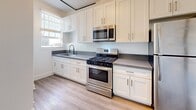 Located at 2505 W 6th St in Los Angeles, CA, this one-bedroom, one-bathroom unit offers a well-designed single-floor layout that maximizes every square foot. Light wood-style flooring flows throughout, creating a cohesive and airy feel across all rooms.

The kitchen and dining area are combined into a functional open space, featuring crisp white shaker cabinetry extending to the ceiling for ample storage, gray countertops, and a full suite of stainless steel appliances including a gas range, built-in microwave, and refrigerator. A window over the sink brings in natural light, enhancing the clean, modern aesthetic.

The generously sized primary bedroom is a standout feature of the unit, comfortably accommodating large furniture. It includes mirrored sliding closet doors, a ceiling fan, dual windows overlooking the neighborhood, and a classic radiator. Three closets throughout the unit provide exceptional storage.

The bathroom is bright and well-appointed, with white subway tile surrounding the soaking tub and shower combination, light wood-style flooring, a white vanity with gray countertop, and a window that allows natural light to fill the space. A hallway and entrance area complete the thoughtful layout, making this unit a practical and stylish home in the heart of Los Angeles.