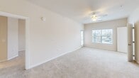 This contemporary apartment, located at 9001 Mason Village Loop in Manassas, VA, offers 1120 square feet of thoughtfully designed living space. The single-story layout includes three bedrooms, with the primary bedroom boasting a generous 200 square feet. Two full bathrooms provide convenience for residents and guests alike.

The kitchen is a highlight, featuring modern stainless steel appliances, rich wood cabinetry, and sleek granite countertops. The open concept design flows seamlessly into other living areas, creating an inviting atmosphere for both everyday life and entertaining.

Throughout the apartment, you'll find a harmonious blend of materials, including plush carpeting in the bedrooms and stylish wood-look flooring in the main living areas and bathrooms. Large windows in the bedrooms allow for ample natural light, while ceiling fans ensure comfort year-round.

Storage solutions are plentiful, with two dedicated closet spaces and additional built-in shelving. The bathrooms showcase contemporary fixtures, including vanities with granite countertops and tub/shower combinations.

The neutral color palette throughout provides a blank canvas for personal style, while the overall design speaks to modern sensibilities. This well-appointed apartment offers a perfect balance of comfort, functionality, and style for today's discerning renter.