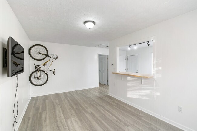 Living room area with vinyl plank flooring. - 618 E 5th Street