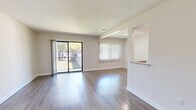 This single-floor, 2-bedroom, 2-bathroom unit offers a thoughtfully designed layout with modern finishes throughout. The open-concept living room is bright and spacious, featuring light wood-style flooring, neutral walls, and large sliding glass doors that lead to a private balcony, filling the space with natural light and outdoor views. A dedicated window with vertical blinds adds additional brightness to the living area.

The galley-style kitchen is efficiently designed with white shaker cabinetry, granite-patterned countertops, a stainless steel sink, and a full suite of stainless steel appliances including a gas range, microwave, refrigerator, and dishwasher. Light wood flooring continues seamlessly from the living area into the kitchen.

Both bedrooms are carpeted for comfort, with neutral tones and ample natural light from windows with vertical blinds. The primary bedroom is generously sized and features access to a walk-in closet with a rod and shelving system.

The two bathrooms are finished with granite-top white vanities and wood-look flooring. The full bathroom includes a soaking tub with floor-to-ceiling tile surround and brushed nickel fixtures, while the second bathroom offers a clean, functional design. Two hallways connect the space efficiently, and a dedicated closet provides additional storage.