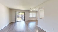 This single-floor, 2-bedroom, 2-bathroom unit offers a thoughtfully designed layout with modern finishes throughout. The open-concept living room is bright and spacious, featuring light wood-style flooring, neutral walls, and large sliding glass doors that lead to a private balcony, filling the space with natural light and outdoor views. A dedicated window with vertical blinds adds additional brightness to the living area.

The galley-style kitchen is efficiently designed with white shaker cabinetry, granite-patterned countertops, a stainless steel sink, and a full suite of stainless steel appliances including a gas range, microwave, refrigerator, and dishwasher. Light wood flooring continues seamlessly from the living area into the kitchen.

Both bedrooms are carpeted for comfort, with neutral tones and ample natural light from windows with vertical blinds. The primary bedroom is generously sized and features access to a walk-in closet with a rod and shelving system.

The two bathrooms are finished with granite-top white vanities and wood-look flooring. The full bathroom includes a soaking tub with floor-to-ceiling tile surround and brushed nickel fixtures, while the second bathroom offers a clean, functional design. Two hallways connect the space efficiently, and a dedicated closet provides additional storage.
