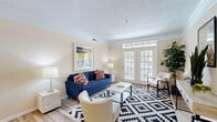 This well-appointed 2-bedroom, 2-bathroom residence at Quarry Lake Drive in Columbus, Ohio offers a thoughtfully designed single-floor layout that maximizes functionality and comfort. The living room serves as the heart of the home, featuring crown molding, light hardwood-style flooring, and large French doors with transom windows that flood the space with natural light and provide access to the outdoors. Adjacent to the living area, the combined dining space connects seamlessly to the kitchen via a peninsula breakfast bar with bar seating, making it ideal for both casual dining and entertaining. The kitchen is equipped with white cabinetry, light countertops, a full suite of white appliances, recessed lighting, and a double-basin sink. Both bedrooms are carpeted and offer a calm, neutral palette with ample natural light from well-placed windows. The primary bedroom is generously sized with sufficient room for a full bedroom suite. Each of the two bathrooms features a tub-shower combination, vanity with a large mirror, and hardwood-style flooring. A dedicated closet provides additional storage. The overall ambiance throughout is warm and inviting, with neutral tones and clean finishes creating a cohesive, livable aesthetic.