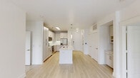 Located in Dallas's vibrant 75206 zip code, this thoughtfully designed 2-bedroom, 2-bathroom residence offers a clean, contemporary aesthetic defined by bright white walls, light-toned hardwood flooring, and an open-concept layout that maximizes the sense of space. The kitchen serves as the heart of the home, anchored by a large central island with a sleek quartz countertop and undermount sink with a professional-style faucet. Crisp white shaker cabinetry — including glass-front upper cabinets — pairs with stainless steel appliances and pendant lighting to create a polished, functional cooking space. The living area flows naturally from the kitchen and is bathed in natural light from large windows. The generously sized primary bedroom features its own well-appointed en-suite bathroom, complete with a dual-sink vanity, a glass-enclosed walk-in shower, a soaking tub, and large-format white tile flooring. A well-organized walk-in closet with built-in shelving and drawers provides ample storage. The second bedroom is bright and airy, with a ceiling fan and an outdoor view. The second bathroom features a tub-shower combination and access to an additional closet. A dedicated laundry area with built-in shelving completes this well-appointed home.