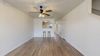 Located at 101 Tiffany Cir in Terrell, TX, this two-story home offers a practical and well-organized layout across two floors, with two bedrooms, three bathrooms, and dedicated spaces for everyday living. The main floor features an open-concept living and dining area with wood-look flooring, crisp white walls, and ceiling fans with light fixtures that keep the space bright and comfortable. A pass-through window connects the living area to the kitchen, which is equipped with warm honey-toned cabinetry, white appliances including a dishwasher, range, and refrigerator, and a built-in nook ideal for a small workspace. A convenient breakfast bar with seating provides a casual dining option. The main floor also includes a laundry area and access to the staircase leading to the upper level. Upstairs, two carpeted bedrooms offer a quiet retreat, each benefiting from natural light through sizable windows with views of the surrounding neighborhood. The spacious primary bedroom features dual windows and ample room for furnishings. Three full bathrooms — each with a tub-shower combination — are distributed across both floors for added convenience. Three closets throughout the home provide generous storage. The neutral color palette and clean finishes create a move-in-ready environment throughout.