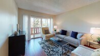 This single-floor residence offers a thoughtfully designed layout that balances comfort and functionality throughout. The living room serves as the heart of the home, showcasing rich hardwood flooring, a textured ceiling, and a large sliding glass door that opens to a private balcony with views of lush greenery, filling the space with abundant natural light. The open, welcoming atmosphere makes it ideal for both relaxing and entertaining.

The kitchen is well-equipped, featuring warm wood cabinetry, granite countertops, a double stainless steel sink, and stainless steel appliances. A window above the sink allows natural light to brighten the workspace. Consistent granite countertops also appear in the bathroom, which includes a wide vanity with dual mirrors and a separate toilet and shower area.

The two bedrooms are carpeted for comfort and feature soft, neutral tones with windows that allow natural light to filter in. Each room offers a calm, restful environment well-suited for relaxation. A dedicated laundry closet houses a stacked washer and dryer unit, adding significant convenience to daily living.

Throughout the residence, neutral wall tones, consistent finishes, and a practical, connected floor plan create a cohesive and comfortable living environment.