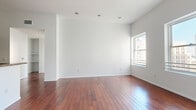 Located in the heart of Downtown Los Angeles, this thoughtfully designed 2-bedroom, 2-bathroom residence offers a refined urban living experience. Rich hardwood flooring flows throughout the main living areas and bedrooms, complemented by soaring ceilings and crisp white walls that create a bright, airy atmosphere. The spacious living area features recessed lighting and a large window that fills the room with natural light and city views.

The well-appointed kitchen is a standout feature, boasting rich dark mahogany cabinetry, granite countertops, stainless steel appliances including a range, microwave, and dishwasher, and light tile flooring — a perfect combination of style and functionality.

Both bedrooms are generously sized, each featuring floor-to-ceiling mirrored sliding closet doors that amplify light and space, along with windows framing views of the surrounding cityscape. The soaring ceiling height in the bedrooms adds to their open, expansive feel.

The two bathrooms are elegantly finished with travertine tile, granite-topped vanities with rich wood cabinetry, and chrome fixtures. One bathroom offers a glass-enclosed walk-in shower, while the other features a soaking tub with a glass shower enclosure. Every detail reflects a clean, modern aesthetic suited for sophisticated city living.