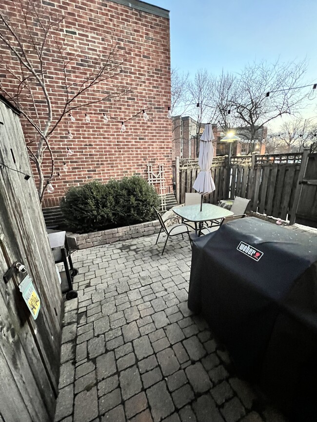 Back patio complete with grill, patio furniture and large shed. Back gate opens to parking spot. - 2141 N Larrabee St