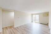 Located at 18 Anthony Rd in New London, Connecticut, this two-bedroom, one-bathroom residence offers a well-organized single-floor layout designed for comfortable everyday living. The open living and dining area is bright and airy, finished with light hardwood-style flooring that runs throughout the main living spaces. Large sliding glass doors lead to a private balcony, allowing natural light to fill the room and providing a pleasant outdoor connection. The kitchen features warm oak cabinetry, light stone-patterned countertops, and white appliances including a range and dishwasher, offering a functional and efficient cooking space. Both bedrooms are carpeted for comfort and include generous closet space with double-door closets, along with windows that bring in natural light. The full bathroom is clean and simply appointed, featuring a tub-shower combination, a single vanity, and light flooring that complements the rest of the home. A dedicated entrance, hallway, and an impressive six closets throughout the unit ensure excellent storage capacity. The neutral warm-white color palette and consistent finishes create a cohesive and welcoming ambiance throughout this well-maintained New London residence.