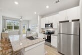 Step into a world of possibilities in this exquisite 1,020 sq ft residence, where every detail has been crafted to elevate your everyday living. The heart of this home is the gourmet kitchen, a culinary enthusiast's dream come true. Sleek white cabinetry, gleaming stainless steel appliances, and luxurious granite countertops create a space that's both functional and visually striking. The open-concept design seamlessly connects the kitchen to the living areas, perfect for entertaining or enjoying quiet evenings at home.

Natural light floods the living spaces through large windows, creating an airy and inviting atmosphere. The primary bedroom, a generous 160 sq ft retreat, offers a peaceful sanctuary for relaxation and rejuvenation. Both bathrooms boast modern fixtures, ample storage, and a spa-like ambiance, promising a luxurious start and end to each day.

Throughout the home, warm wood-look flooring adds a touch of elegance and durability. The second bedroom provides versatility as a guest room, home office, or personal gym. Energy-efficient features, including ceiling fans and modern HVAC systems, ensure year-round comfort while keeping utility costs in check.

This home isn't just a place to live; it's a canvas for your dreams and aspirations. Whether you're a young professional, a small family, or someone looking to downsize in style, this property offers the perfect backdrop for the life you've always imagined. Welcome home to your future.