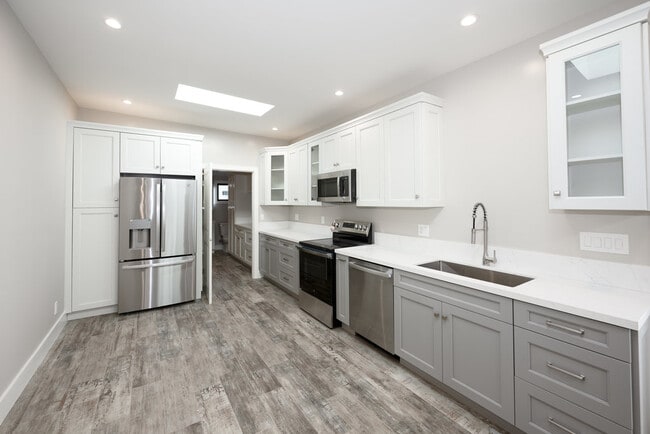 View of kitchen with bath/laundry through the doorway. - 498 S Marengo Ave