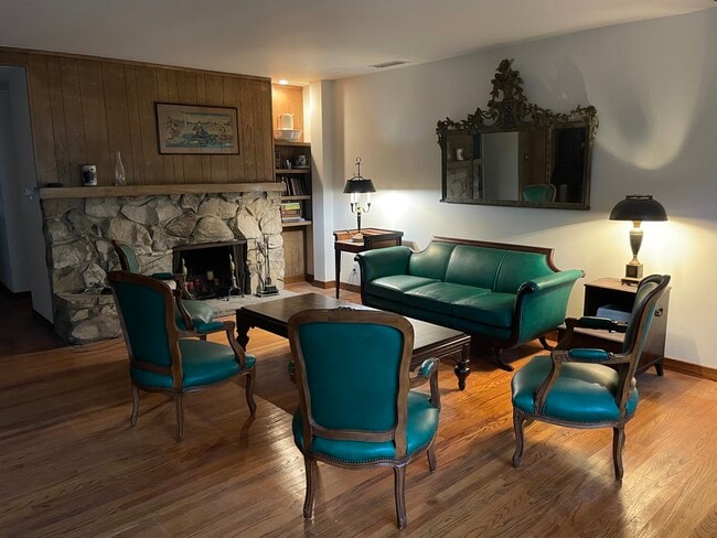 Classical antiques and leather upholsterd furniture compliments the mid century architecture - 11449 Woodbine St