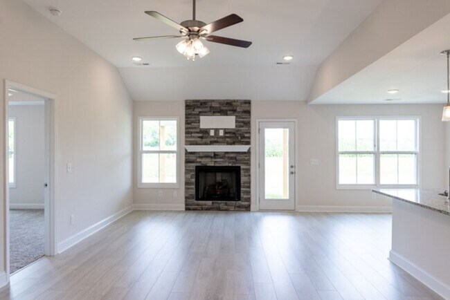 Building Photo - Modern Living Redefined with Stone Fireplace, Gray Cabinetry, Spa Inspired Primary Suite and Cove...