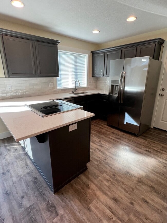 Building Photo - Remodeled Home with New Flooring, Quart Counters, W/D, Fenced Yard, Parking & MORE!