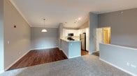 This single-floor residence offers a well-designed layout that balances open communal spaces with comfortable private areas. The heart of the home is an open-concept kitchen and living area, where vaulted ceilings and crown molding add architectural character. The kitchen is outfitted with white shaker-style cabinetry, a tiled backsplash, stainless steel appliances including a gas range, built-in microwave, and refrigerator, along with a peninsula featuring a double undermount sink—ideal for both cooking and casual dining. Rich hardwood-style flooring flows through the kitchen and dining areas, while plush carpet covers the living room and bedrooms.

The spacious living room features a tile-surround fireplace and sliding glass door that invites natural light. The bedrooms are generously sized, each with ceiling fans, soft carpet, and windows offering outdoor views. The bathrooms are finished with neutral gray walls, white vanities with ample counter space, wall-mounted cabinetry, and tub/shower combinations accented with tile detailing. Throughout the residence, a consistent neutral color palette and clean finishes create a cohesive, move-in-ready atmosphere.