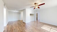 This contemporary 880 square foot apartment in Austin, Texas offers a well-designed living space with two bedrooms and two bathrooms. The single-story layout maximizes efficiency, with the primary bedroom boasting a generous 160 square feet. Throughout the apartment, warm hardwood floors create a cohesive and inviting atmosphere.

The open-concept design seamlessly integrates the kitchen, living, and dining areas, promoting a spacious feel. The kitchen features light gray cabinetry, white appliances, and ample counter space, ideal for meal preparation. Both bathrooms are modernly appointed with white fixtures, tiled showers, and vanities with storage.

Each bedroom is equipped with a ceiling fan and large windows, allowing for natural light and air circulation. The apartment includes closet space in both bedrooms and additional storage areas. A covered porch extends the living area outdoors, offering a pleasant spot to enjoy the surrounding neighborhood views.

The property's location at 2340 1/2 Cromwell Circle places residents in the heart of Austin's vibrant community. With its efficient use of space, modern amenities, and prime location, this apartment presents an attractive option for those seeking a comfortable urban dwelling.