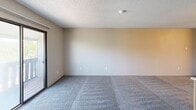 Located at 2720 S Emporia St in Wichita, Kansas, this one-bedroom, one-bathroom apartment offers a compact and functional single-floor layout. The combined kitchen and living area forms the heart of the unit, where a standout freestanding wood-burning fireplace anchors the living space, set on a tiled hearth and positioned beside a sliding glass door that brings in natural light and outdoor access. The living area is carpeted and offers a clean, open feel. The kitchen features warm wood-toned cabinetry, a peninsula with a built-in sink and countertop workspace, hardwood-style flooring, and white appliances including a range and refrigerator, with overhead ventilation and a textured ceiling throughout. The bedroom is a well-proportioned, carpeted room with a window that allows natural light, a closet for storage, and neutral wall tones that create a calm atmosphere. The bathroom includes a full-size tub and shower combo with chrome fixtures and wood-toned overhead cabinetry for added storage. Throughout the unit, textured ceilings, neutral color palettes, and carpet flooring maintain a consistent, practical aesthetic suitable for everyday living.