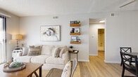 Located at 16425 S Harbor Blvd in Fountain Valley, California, this single-floor, one-bedroom, one-bathroom residence offers a thoughtfully laid-out living space with a clean, modern aesthetic throughout. Light wood-style flooring flows through the main living areas, complementing the neutral color palette that lends the home a bright, airy feel.

The open-concept living, dining, and kitchen area forms the heart of the home. The living room features a large sliding glass door that invites abundant natural light and provides direct access to an outdoor area. The kitchen is well-appointed with white shaker cabinetry, granite-style countertops, stainless steel appliances including a refrigerator, gas range, and microwave, plus a skylight that adds extra brightness. A dedicated dining nook sits adjacent to the kitchen, providing a defined space for meals.

The bedroom is comfortably sized with plush carpeting, a walk-in closet, and a window with a vertical blind treatment. The full bathroom features a tub-shower combination, wood-style flooring, a white vanity with granite countertop, and decorative wall accents. A hallway connects the main spaces efficiently. Overall, the residence offers a functional, well-finished layout suited for everyday living.