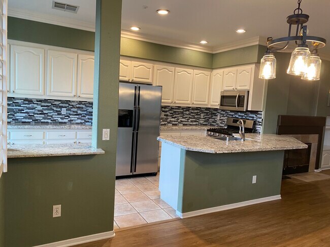 Kitchen with dishwasher, trash compactor, microwave with vent - 557 Sweet Pea Pl