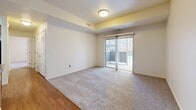 Located in Parker, Colorado, this single-floor, two-bedroom, two-bathroom residence offers a practical and well-appointed layout. The open-concept kitchen is a central feature, equipped with warm wood cabinetry, black appliances including a refrigerator, range, and microwave, and ample counter space. A peninsula with an extended breakfast bar provides additional seating and connects the kitchen seamlessly to the living area. Hardwood-style flooring runs throughout the main living and kitchen spaces, lending a clean, cohesive look.

The living area is carpeted and generously sized, with a sliding glass door that opens to a private balcony, allowing natural light to fill the room. Both bedrooms are carpeted and feature vertical blind-covered windows that provide natural light. The primary bedroom is a comfortable size and connects to the hallway. The second bedroom is similarly finished and bright.

The two bathrooms each include a full soaking tub and shower combination with chrome fixtures, a vanity with storage, and hardwood-style flooring. Additional practical spaces include a dedicated laundry area and two closets for storage. A hallway connects the bedrooms and bathrooms, completing this efficient and functional floor plan.