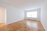 Located at 111 Lawton Blvd in the desirable Forest Hill South neighbourhood of Toronto, this 2-bedroom, 1-bathroom unit offers a clean, functional layout across a single floor. Classic parquet hardwood flooring runs throughout the living areas and both bedrooms, lending a warm, timeless character to the space.

The primary bedroom is generously proportioned, featuring a large window with a radiator beneath it that fills the room with natural light, along with crisp white walls that create a bright, airy feel. The second bedroom is comparably well-sized and similarly finished, offering the same parquet flooring and neutral palette.

The kitchen is efficiently designed, featuring white cabinetry extending to the ceiling for ample storage, a grey stone-look countertop, a stainless steel single-basin sink with a modern chrome faucet, a white subway tile backsplash, and a white range and refrigerator. A hallway connects the rooms and provides a logical flow through the unit.

The bathroom is neatly appointed with large-format light grey floor tiles, a white vanity with a mirror cabinet above, a bar light fixture, a toilet, and a bathtub. The all-white finishes give the bathroom a clean, refreshed appearance.

Overall, the unit presents a bright, well-maintained interior with consistent finishes throughout.