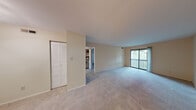 Located at 502 Sarah Ln, Unit 518E in Creve Coeur, MO, this single-floor unit offers a well-organized layout designed for comfortable everyday living. The expansive living area is carpeted throughout and bathed in natural light, with a large sliding glass door that opens directly onto a private balcony overlooking lush greenery — a standout feature that brings the outdoors in. The open layout connects seamlessly to additional rooms, providing a sense of flow and spaciousness throughout. Multiple rooms feature plush carpeting, neutral wall tones, and louvered bi-fold closet doors for ample storage. One room is equipped with a ceiling fan light fixture and an interior pass-through window, adding a distinctive architectural touch. The kitchen is efficiently designed with overhead cabinetry, a coil electric range, and a practical counter workspace, complemented by a nearby louvered closet for added storage convenience. Natural light is present throughout the unit via windows fitted with blinds. The overall ambiance is clean, bright, and neutral, offering a versatile canvas well-suited for a variety of living arrangements. The unit's single-floor design ensures easy accessibility and a cohesive living experience from room to room.