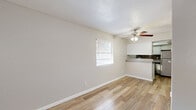 Located at 1901 Brown St in El Paso, Texas, this efficient one-bedroom, one-bathroom residence offers a well-organized single-floor layout designed to maximize every square foot. Wood-look plank flooring flows consistently throughout the home, lending warmth and visual continuity to each room.

The combined living and dining area serves as the heart of the space, featuring a ceiling fan with light fixture and a window that brings in natural light. It connects seamlessly to the kitchen via a pass-through counter with overhead cabinetry, accented by a decorative tile backsplash. The kitchen is equipped with white cabinetry and a stainless steel refrigerator, offering a clean, functional workspace.

The bedroom is a comfortably sized retreat featuring its own ceiling fan, a window with blinds for natural light and privacy, and access to ample storage through three closets distributed throughout the home. Neutral-toned walls throughout create a calm, versatile backdrop.

The bathroom includes a full tub and shower combination with large-format marble-style tile surround, a toilet, and a vanity, all finished with the same wood-look flooring that carries through the rest of the unit. Textured walls and ceilings add architectural character to this practical and move-in-ready El Paso residence.