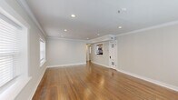 Located on Emanuel Cleaver II Blvd in Kansas City, MO, this single-floor, two-bedroom, one-bathroom residence offers a well-designed layout with quality finishes throughout. The living area is generously proportioned, featuring warm hardwood floors, crown molding, and recessed lighting that create a bright, polished atmosphere. A pass-through opening connects the living space to the kitchen, enhancing the open feel of the unit.

The kitchen is well-appointed with white shaker-style cabinetry, granite countertops, a classic white subway tile backsplash, and a full suite of stainless steel appliances including a gas range, dishwasher, and over-the-range microwave. Stone tile flooring completes the functional, clean aesthetic.

Both bedrooms continue the hardwood flooring and crown molding found throughout the home. Each room benefits from natural light via white-trimmed windows with blinds. One bedroom includes a sliding-door closet with built-in shelving. The bathroom features floor-to-ceiling white subway tile in the walk-in shower, a recessed niche, hexagonal mosaic tile flooring, and a small window for natural light—combining classic design with modern detail.