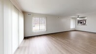 Located at 511 Payne Hill Rd in Jefferson Hills, PA, this two-story home offers three bedrooms and two full bathrooms across two well-proportioned floors. The main level features an open-concept kitchen and living room, where rich dark-espresso cabinetry pairs with granite countertops and a classic subway tile backsplash. Stainless steel appliances, including a refrigerator, range, microwave, and dishwasher, complete the kitchen. Light hardwood-style flooring flows throughout the main living areas, enhancing the bright, airy atmosphere created by large windows with vertical blinds. The spacious living room benefits from natural light and outdoor views of the surrounding wooded landscape. Upstairs, three carpeted bedrooms provide comfortable retreats, each with windows that bring in natural light. The primary bedroom offers a generous footprint with closet access. Two full bathrooms feature dark vanity cabinetry, white tiled tub-shower combos, and light hardwood-style flooring. Additional conveniences include a dedicated laundry area, utility room, and ample closet storage. A staircase with clean white railings connects both levels seamlessly, rounding out this well-appointed, move-in-ready home.