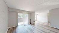 Located at 120 Elm St in Edgewater Park, New Jersey, this single-floor residence offers a clean, updated interior with a bright and neutral design palette. The open living and dining areas are finished with light-toned wood-style flooring that extends throughout the main spaces, creating a cohesive and airy feel. Large sliding glass doors dressed with vertical blinds flood the living area with natural light and provide direct access to an outdoor space, while additional windows offer views of surrounding greenery.

The kitchen is a standout feature, showcasing high-gloss white cabinetry, marble-look countertops, a stainless steel gas range with a wall-mounted range hood, and a single basin sink — combining modern style with functional design. The light wood-style flooring continues seamlessly into the kitchen, maintaining visual flow throughout.

The bedroom is carpeted in soft grey, providing a comfortable and quiet retreat, and is well-lit by a large window with outdoor views. The bathroom is clean and functional, featuring a full soaking tub with a shower, grab bars for added accessibility, and a crisp all-white finish. The overall ambiance of this residence is fresh, minimalist, and move-in ready.