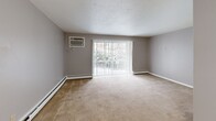 Located at 600 Stevens Dr in Pittsburgh, PA, this two-bedroom, one-bathroom unit offers a practical and comfortable single-floor layout. The living room serves as the heart of the home, featuring wall-to-wall carpeting, a wall-mounted air conditioning unit, baseboard heating, and a sliding glass door that fills the space with natural light and provides outdoor views. An additional entry wall features two closets, offering generous storage right from the start.

Both bedrooms are carpeted and equipped with ceiling fans with integrated lighting. The primary bedroom includes a built-in closet and connects conveniently to the rest of the unit, while the second bedroom benefits from a bright window with outdoor views and baseboard heating. A third bedroom image reveals an additional room with two closets and a ceiling fan, providing ample storage and comfort.

The bathroom features classic tile wainscoting in a soft yellow tone, tile flooring, a white vanity with under-cabinet storage, and a large mirror above the sink, creating a clean and functional space.

Throughout the unit, neutral gray walls, white trim, and consistent carpeting create a cohesive and move-in ready aesthetic. Baseboard heating is present in multiple rooms, ensuring efficient warmth throughout the colder Pittsburgh seasons.