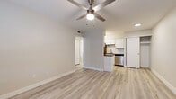 Located at 4707 E McDowell Rd in Phoenix, AZ, this well-designed one-bedroom, one-bathroom unit offers a smartly organized single-floor layout. Light wood-style luxury vinyl flooring runs throughout the entire space, creating a cohesive and clean aesthetic from room to room.

The open living area is bright and welcoming, featuring a ceiling fan with light fixture and neutral-toned walls that maximize the sense of space. A window with slatted blinds allows natural light to filter in, adding warmth to the room. The front entry door is conveniently accessible from the living area.

The kitchen is efficiently laid out and well-appointed with white shaker-style cabinetry, white subway tile backsplash, dark countertops, a stainless steel refrigerator, dishwasher, and a dedicated cooktop area. A peninsula counter provides a natural visual separation between the kitchen and living space.

The bedroom is a comfortable, quiet retreat with its own ceiling fan, a window with blinds for natural light and privacy, and a closeted entry. The hallway connects the main areas seamlessly and leads to the bathroom, which features white cabinetry, dark countertops, a large mirror, and stylish vanity lighting — maintaining the modern, consistent design found throughout the unit.