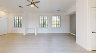 Located in Buckeye, AZ, this well-designed one-bedroom, one-bathroom unit offers a comfortable and modern living experience across a single floor. Light wood-style flooring flows throughout, complementing the crisp white walls and creating a bright, cohesive aesthetic.

The open-concept kitchen and living area serves as the heart of the unit. The kitchen is outfitted with stainless steel appliances, including a refrigerator, electric range, and over-the-range microwave. Two-tone cabinetry — dark lower cabinets paired with white uppers — frames a clean quartz-style countertop and a tasteful mosaic tile backsplash. A kitchen island provides additional counter space and a natural transition into the living area, which features multiple windows with blinds, flooding the room with natural light, and a ceiling fan overhead.

The spacious bedroom continues the light, airy feel with large windows and a ceiling fan. It connects to a generously sized walk-in closet with dual hanging rods. The bathroom offers a tiled walk-in shower with sliding glass doors, a white vanity, and a window for natural ventilation.

A sliding glass door in the living area opens to a balcony with views of palm trees and the surrounding landscape, adding a desirable indoor-outdoor connection to this clean, move-in-ready unit.