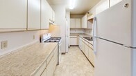 Located at 101 Civic Center Dr NE in Rochester, MN, this single-floor residence offers a practical and comfortable layout designed for everyday living. The galley-style kitchen is well-equipped with ample cream cabinetry, light-toned countertops, a gas range, dishwasher, and a full-size refrigerator, all set on easy-care tile flooring. The spacious living area features plush carpeting, a textured ceiling, and multiple windows that fill the room with natural light and provide open views of the surrounding area. The bedrooms are carpeted and generously sized, each offering natural light through window blinds and practical storage with built-in closets, including both sliding and bifold door styles with hanging rods. Two full bathrooms serve the residence — one featuring a tub/shower combo with a large vanity mirror and warm wood cabinetry, and the other offering a stand-alone shower unit with matching wood vanity. Throughout the space, a neutral color palette of warm whites and beige tones creates a clean, cohesive aesthetic. The efficient floor plan, as seen in the 3D model, ensures a smooth flow between all areas, making this a functional and comfortable residence in the heart of Rochester.