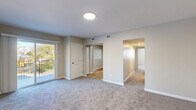 Located at 456 Elm St in Pottstown, PA, this single-floor, 2-bedroom, 2-bathroom home offers a well-organized and functional layout. The living room is generously sized, featuring soft carpeting, neutral warm-toned walls, and a sliding door that opens to an outdoor balcony with pleasant views of surrounding greenery. Adjacent to the living area, the dining room connects seamlessly to the kitchen, which is equipped with black appliances including a range and over-the-range microwave, white cabinetry, granite-style countertops, and light hardwood-style flooring. The spacious primary bedroom offers ample room and includes closet access. The second bedroom is well-proportioned with carpeted flooring, a window for natural light, and a closet. Both bathrooms are clean and bright; one features light hardwood flooring, a white vanity with under-cabinet storage, a lighted mirror, and a bathtub. Throughout the home, five closets provide exceptional storage. A hallway connects the bedrooms and bathrooms with ease. The utility room adds practical convenience. Neutral tones and consistent finishes lend a cohesive, move-in-ready feel to the entire space.