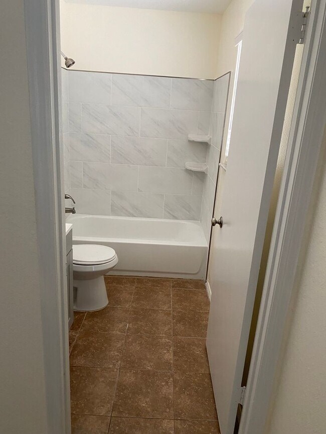 Building Photo - 2/2/1 home with a spacious fenced backyard...
